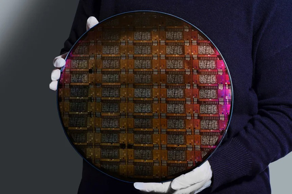 Un cercetător IBM ține în mână waferul